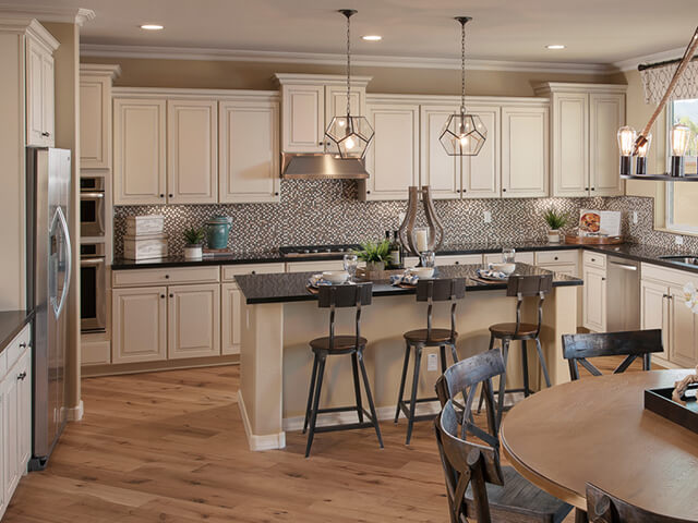 Kitchen with granite island and light hardwood