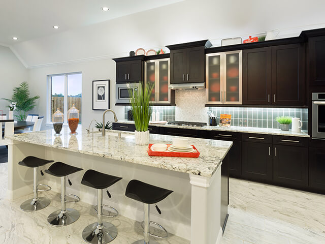 Modern kitchen with black bar stools and white granite