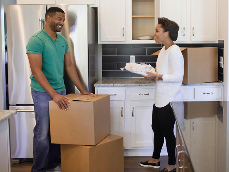 Man and woman unpacking boxes in the kitchen