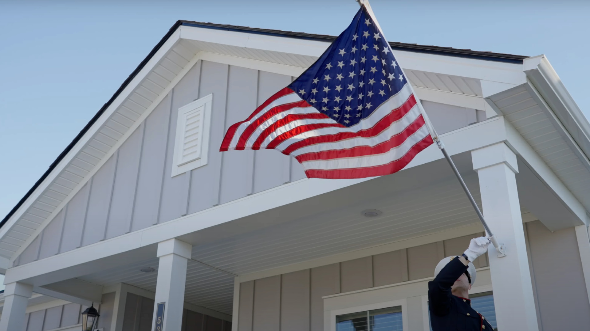 Flag waving in front of home for Operation Homefront Video