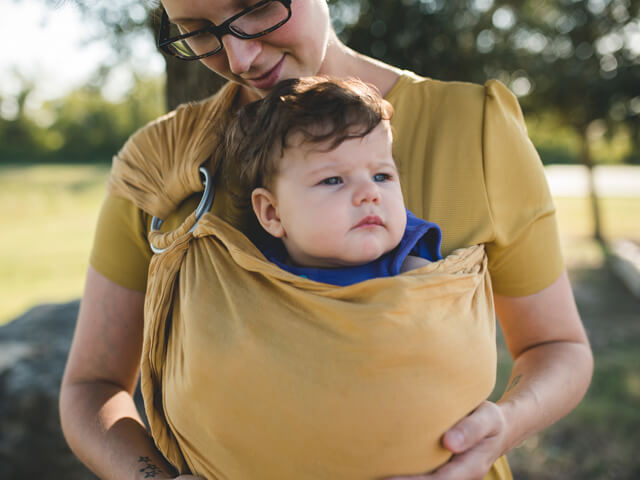Woman holding baby in a baby sling
