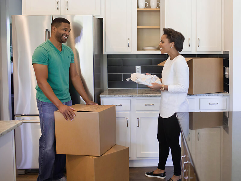 Couple unpacking boxes during their move