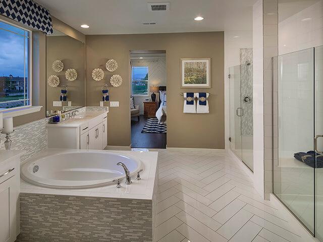 Bathroom with circular tub and beige wall