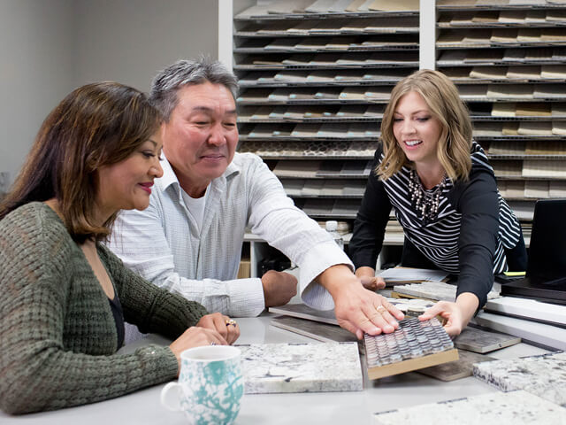 Man feels the texture of a tile sample provided by a salesperson