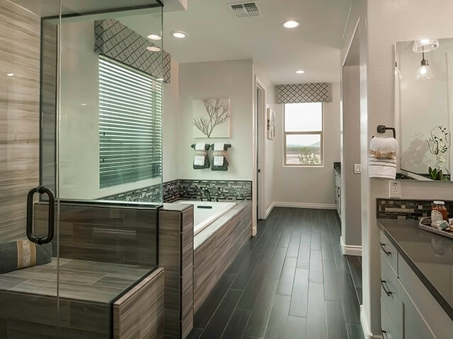 Modern bathroom with large tub and dark floors
