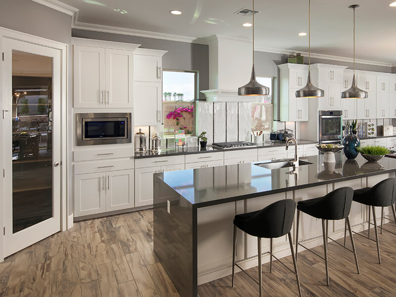 Kitchen with dark granite and white cabinets