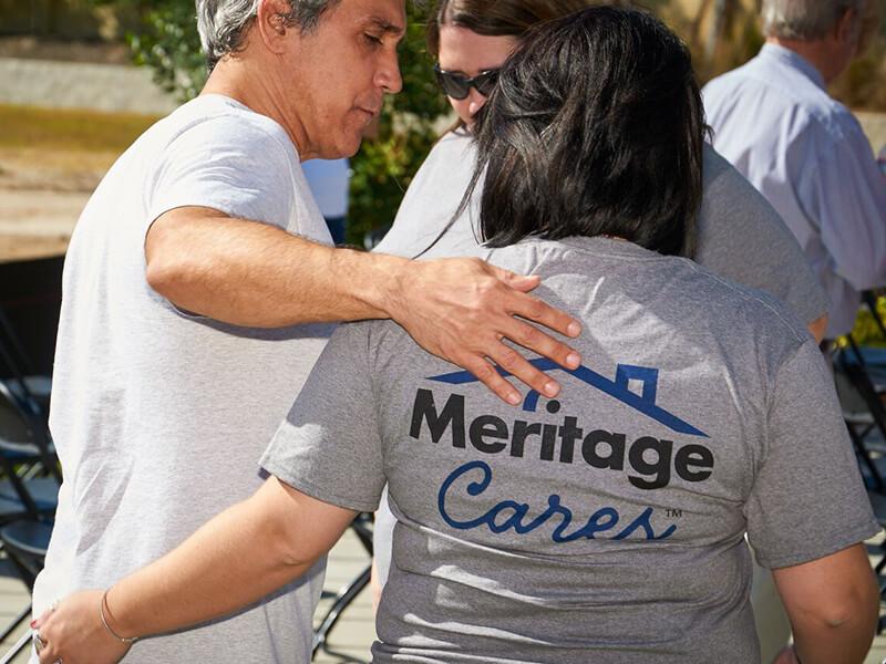 Woman wearing Meritage Cares t-shirt walking with a friend