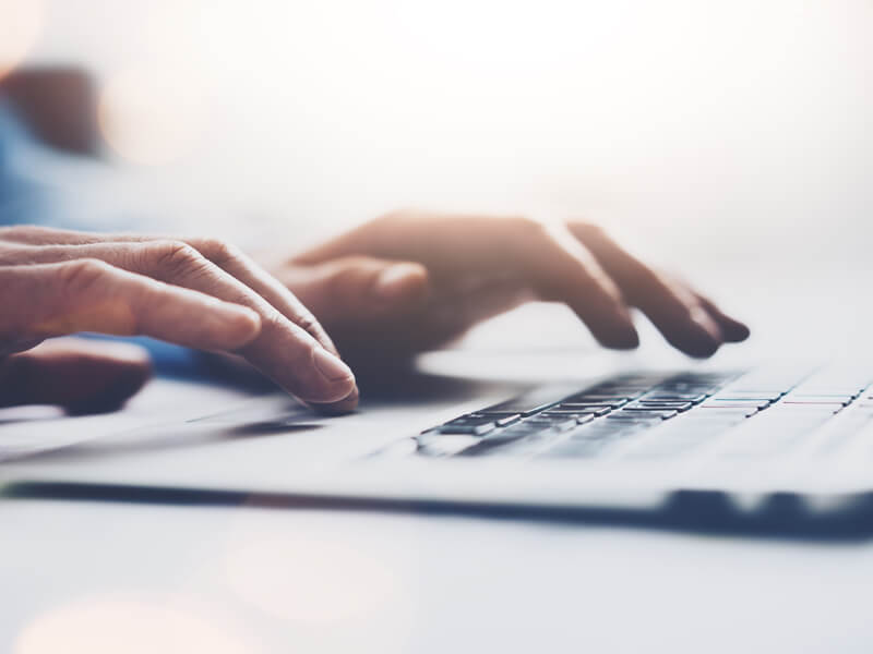 Hands typing on keyboard