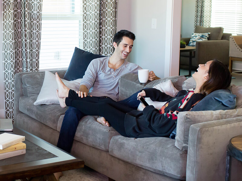 Couple laughing together on couch