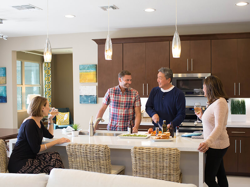 Two couples preparing dinner in the kitchen